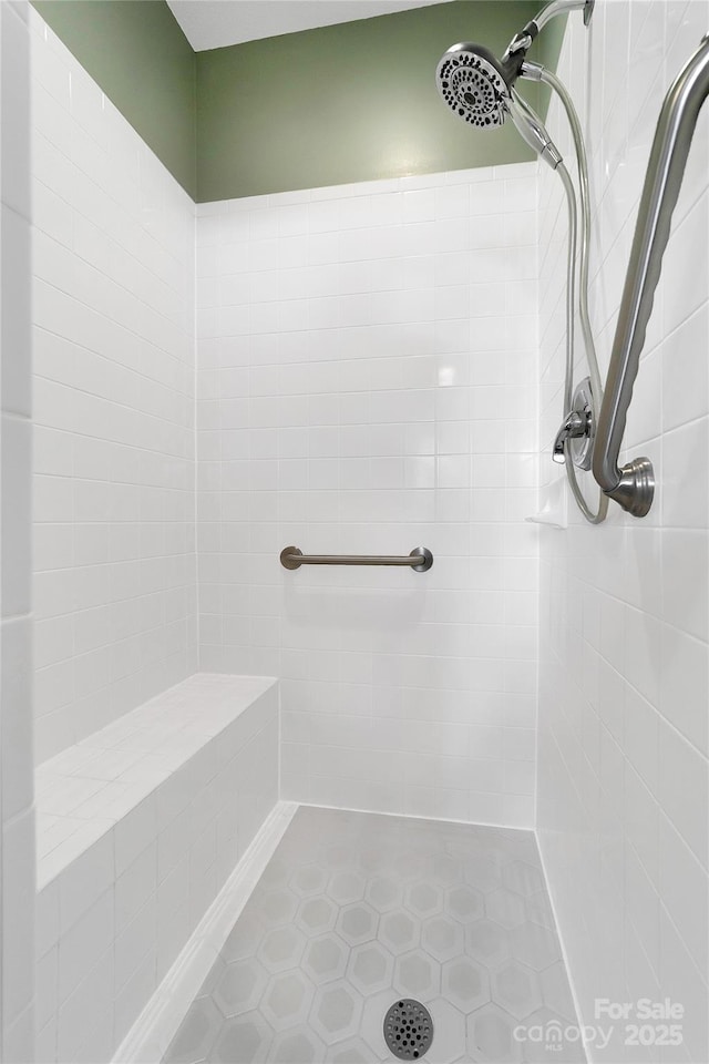 bathroom with a tile shower