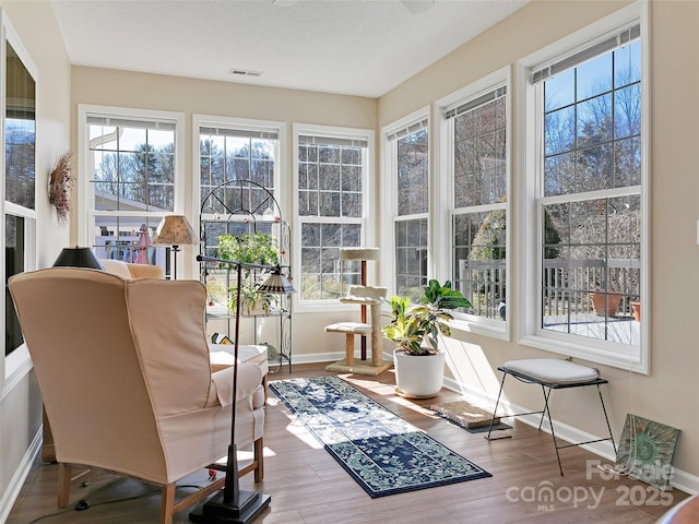 sunroom featuring visible vents and plenty of natural light