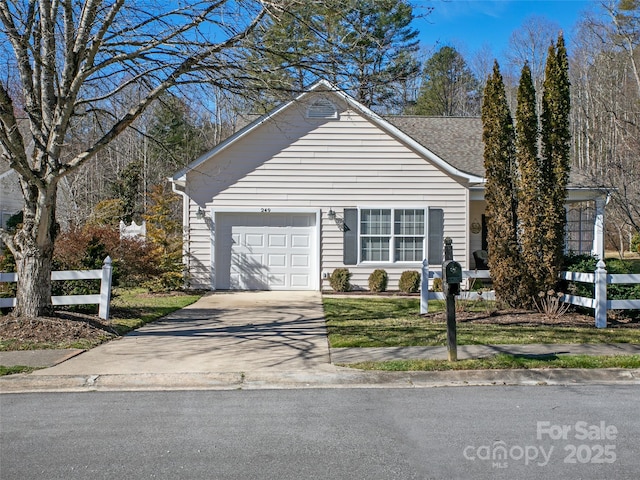 view of front of home with a garage, concrete driveway, and roof with shingles