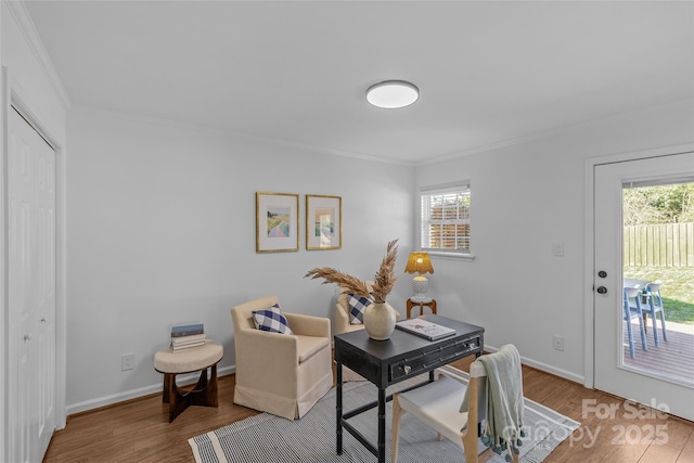 office area with crown molding, baseboards, and wood finished floors