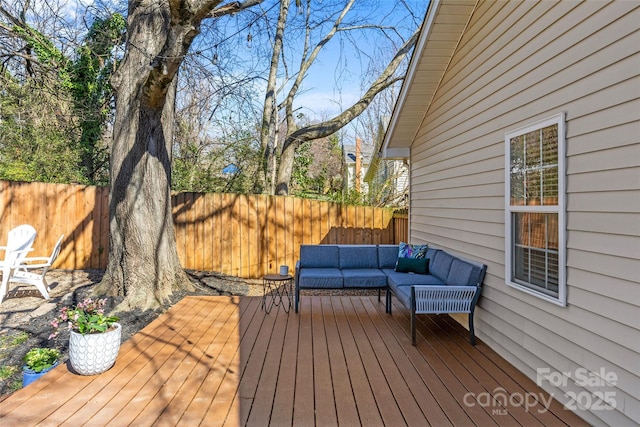 deck featuring a fenced backyard and an outdoor living space