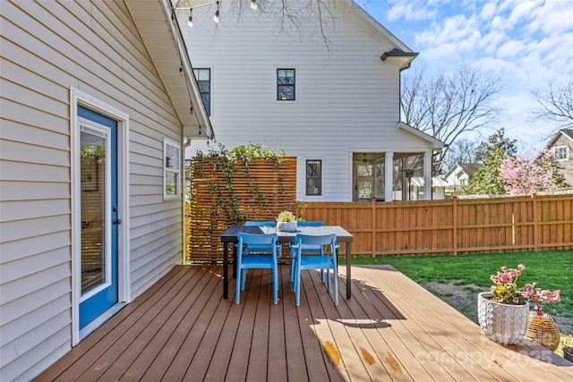 wooden deck featuring outdoor dining space and fence