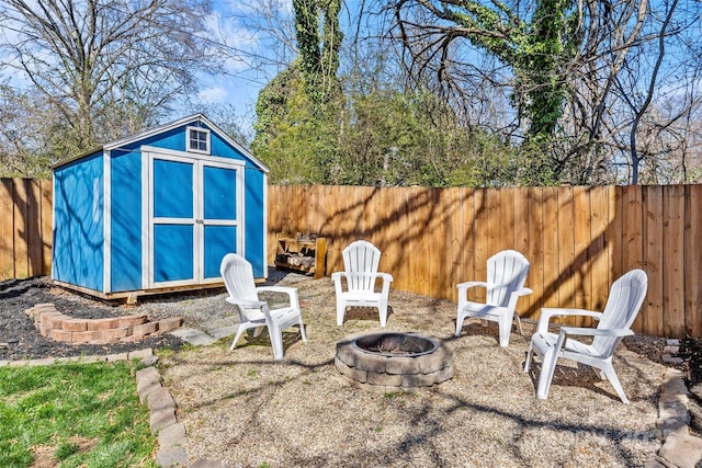 view of shed with an outdoor fire pit and a fenced backyard