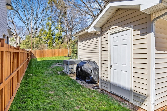 view of yard with central air condition unit and a fenced backyard