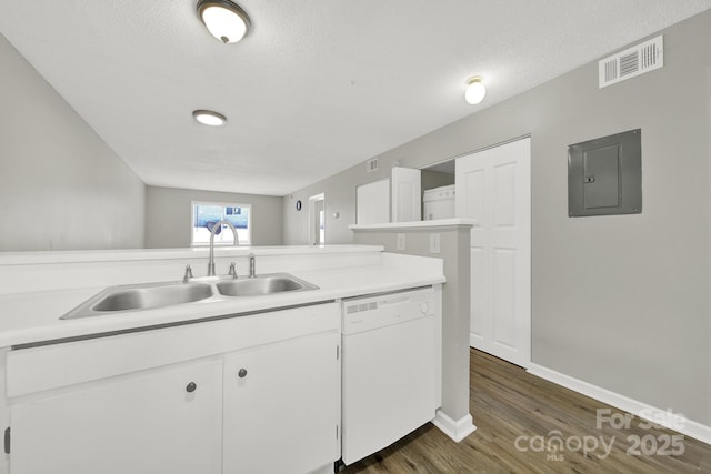 kitchen featuring electric panel, visible vents, dishwasher, light countertops, and a sink