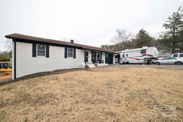 single story home featuring brick siding