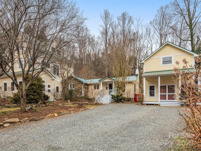 view of front of house with driveway and metal roof