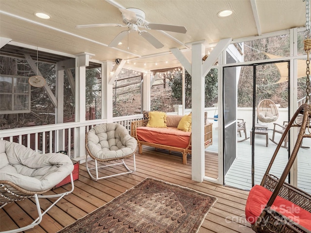 sunroom / solarium with a ceiling fan