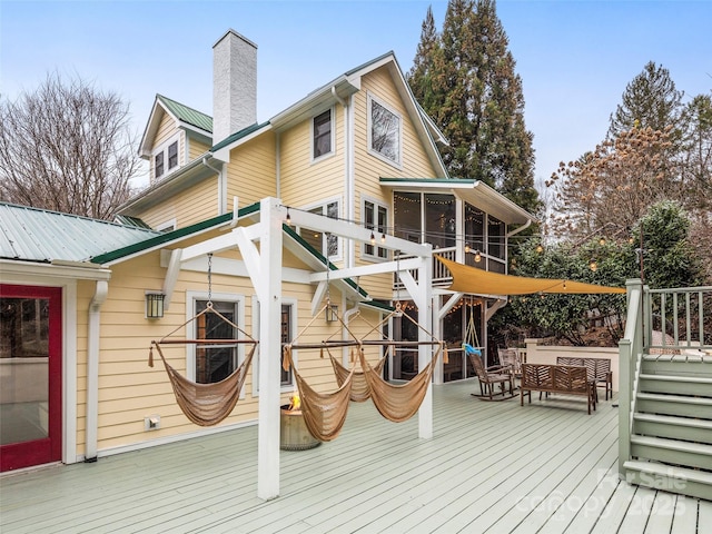 wooden terrace featuring a sunroom