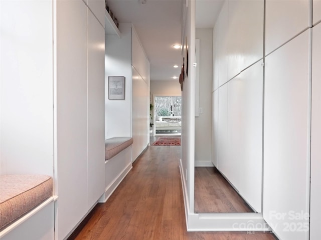 corridor featuring wood finished floors and recessed lighting