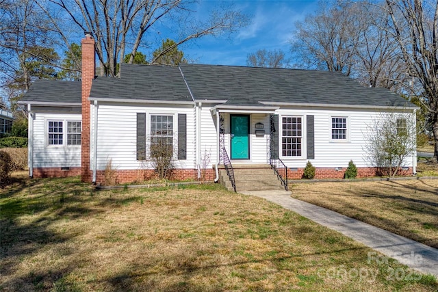 view of front of home with crawl space, roof with shingles, a chimney, and a front lawn