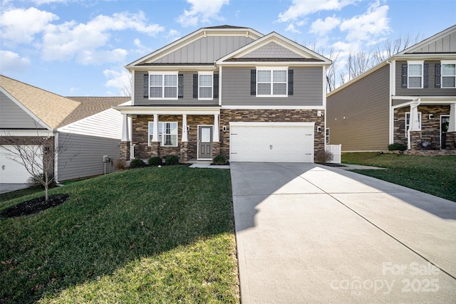 craftsman house featuring a front lawn, a garage, board and batten siding, and driveway