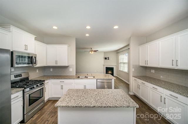 kitchen featuring dark wood-type flooring, white cabinets, and stainless steel appliances