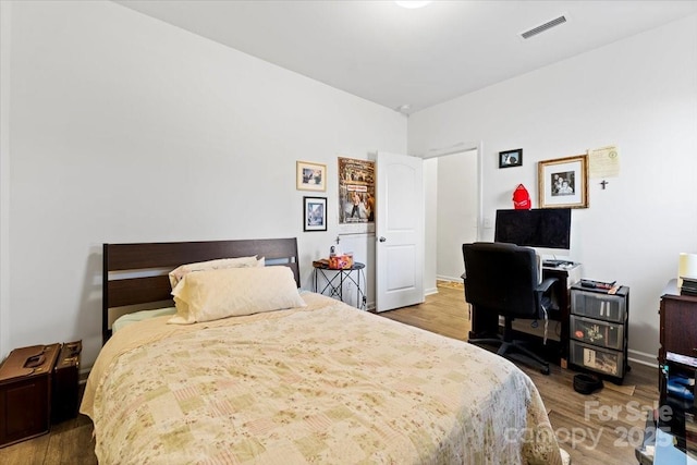 bedroom with visible vents and wood finished floors