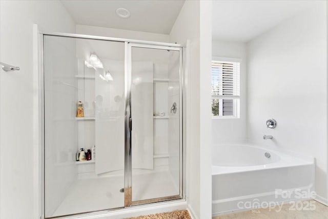 bathroom with a garden tub and a shower stall