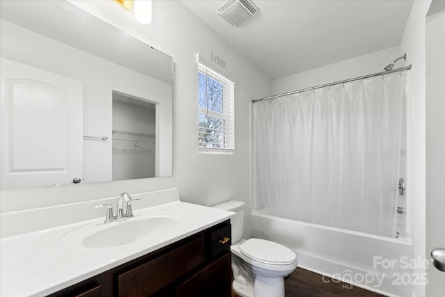 bathroom featuring shower / bathtub combination with curtain, visible vents, vanity, and toilet