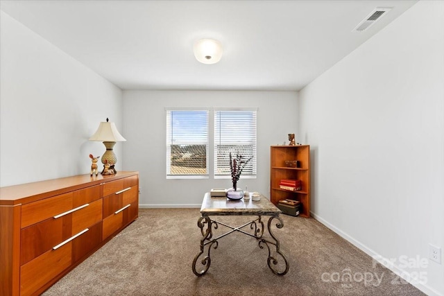 office area with baseboards, visible vents, and light colored carpet