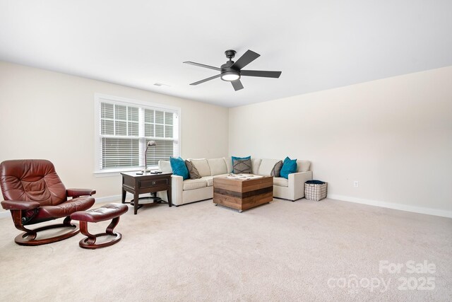 living area with ceiling fan, carpet floors, visible vents, and baseboards