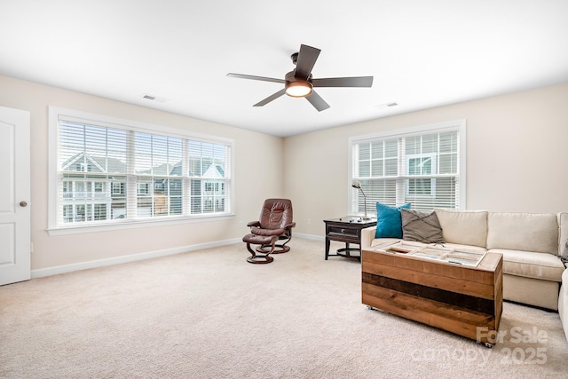 living area featuring carpet, visible vents, ceiling fan, and baseboards