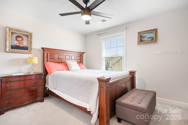 bedroom featuring ceiling fan, baseboards, visible vents, and light colored carpet