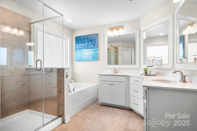 bathroom featuring a garden tub, a shower stall, vanity, and tile patterned floors