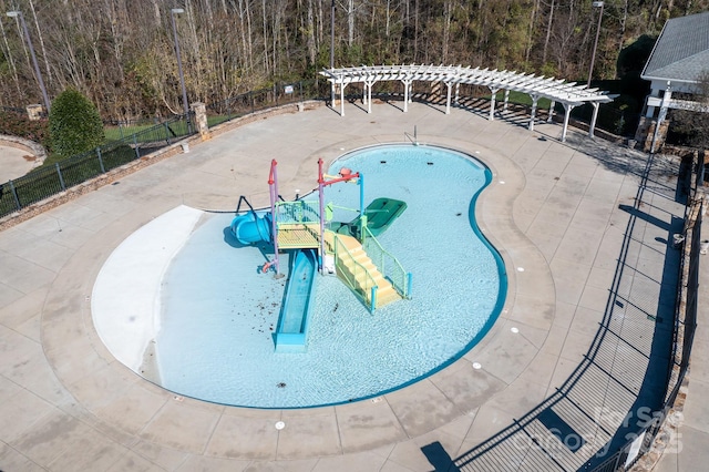 view of swimming pool featuring fence and a pergola