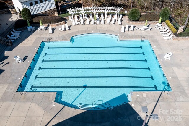 community pool with a patio area