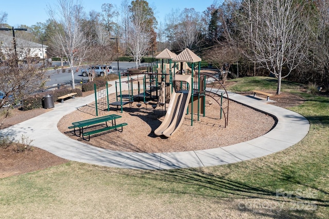 communal playground featuring a lawn