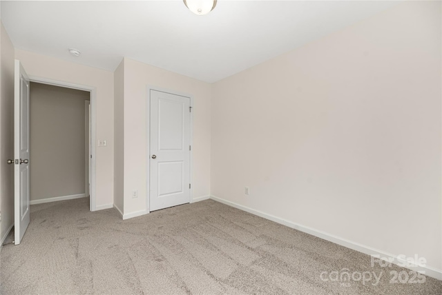 unfurnished bedroom with carpet and baseboards