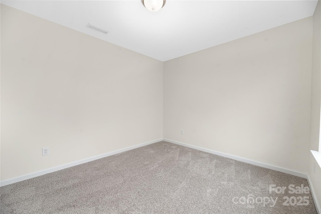 carpeted empty room with visible vents and baseboards