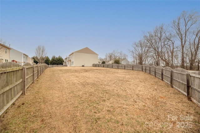 view of yard with a fenced backyard