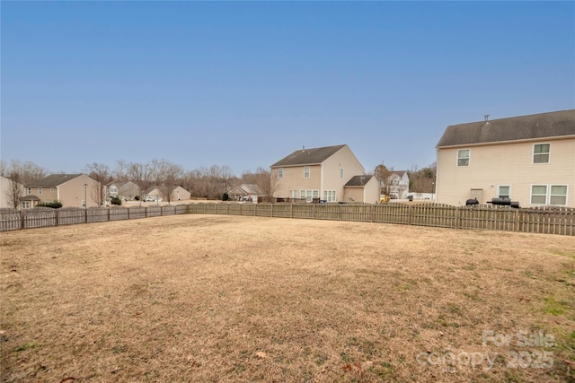 view of yard with a fenced backyard and a residential view