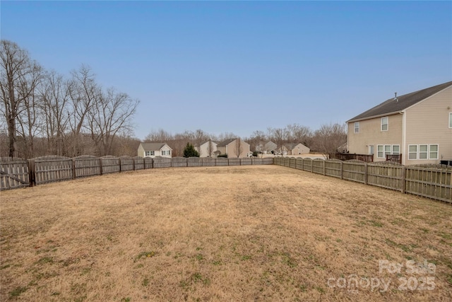 view of yard with a residential view and a fenced backyard