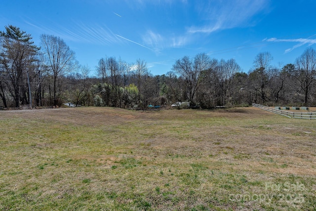 view of yard featuring a rural view and a wooded view