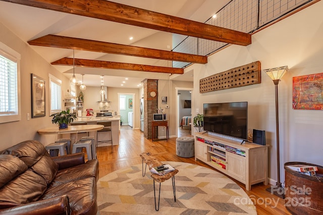 living room with light wood-style floors, beamed ceiling, high vaulted ceiling, and baseboards