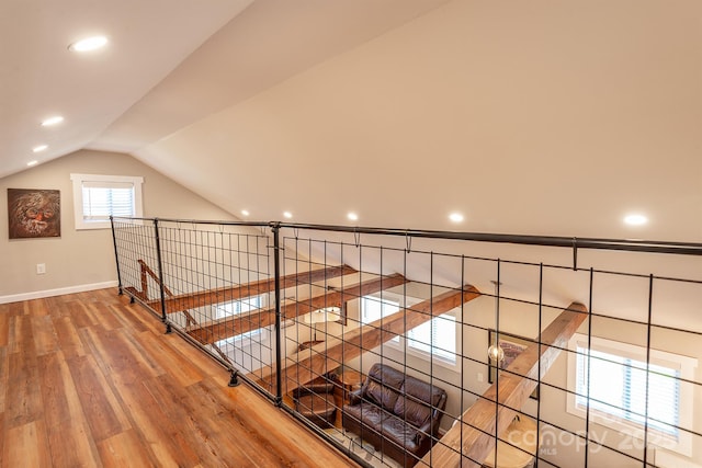 interior space with lofted ceiling, wood finished floors, and baseboards