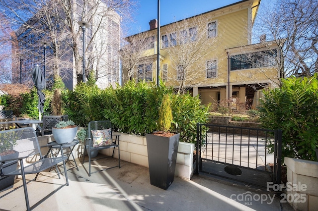 view of patio featuring a gate and fence