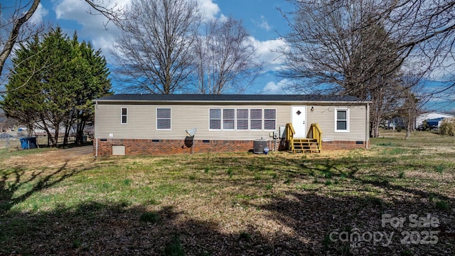 exterior space featuring a yard, central AC unit, and crawl space