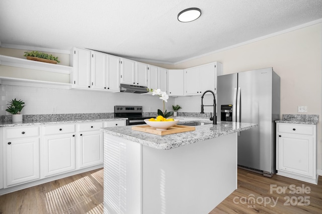 kitchen with open shelves, stainless steel appliances, white cabinets, a sink, and under cabinet range hood