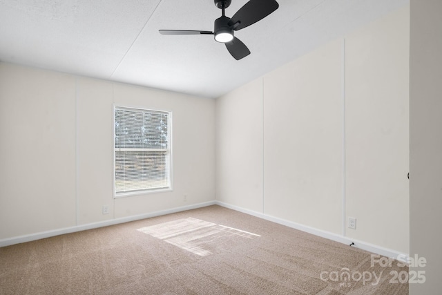 spare room with ceiling fan, baseboards, and carpet flooring