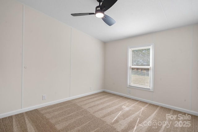 spare room with carpet, ceiling fan, and baseboards