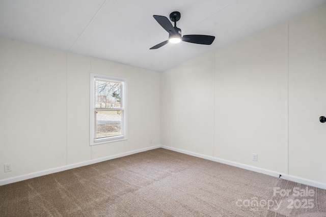 spare room with a ceiling fan, carpet, and baseboards