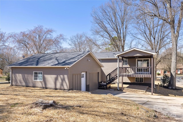 view of front of home featuring covered porch and stairway