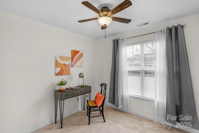 office area with light carpet, baseboards, visible vents, and ceiling fan