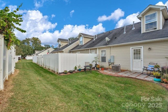 rear view of property with central AC, a lawn, a patio, and fence