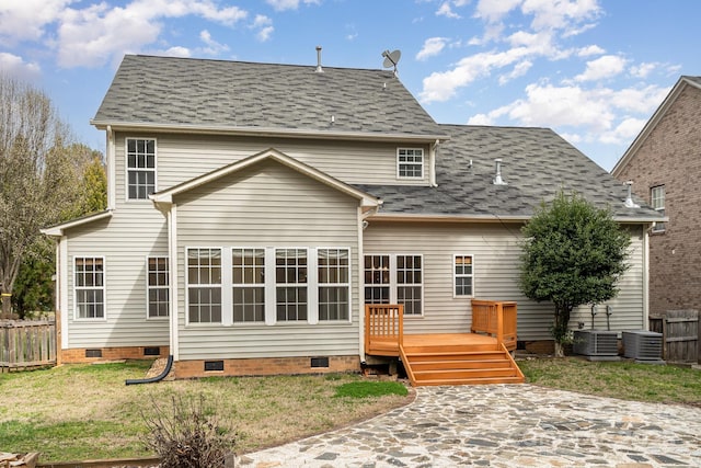 back of property with crawl space, fence, a wooden deck, and a lawn