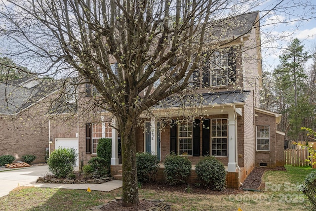 view of front of property featuring driveway, brick siding, crawl space, and fence