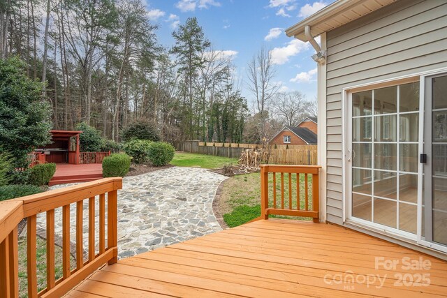 wooden terrace featuring fence