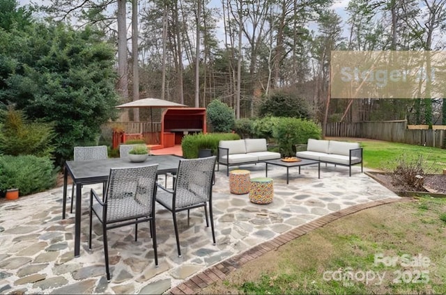 view of patio featuring outdoor dining area, fence, and outdoor lounge area