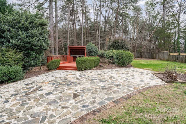 view of patio / terrace featuring fence and a deck